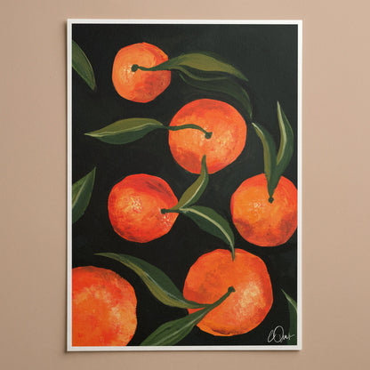 Framed artwork of oranges on a dark background