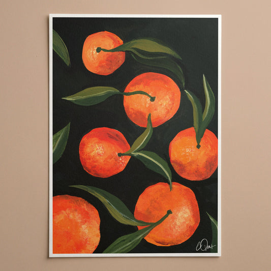 Framed artwork of oranges on a dark background
