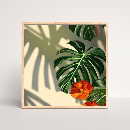Framed artwork with tropical leaves and flowers on a light background